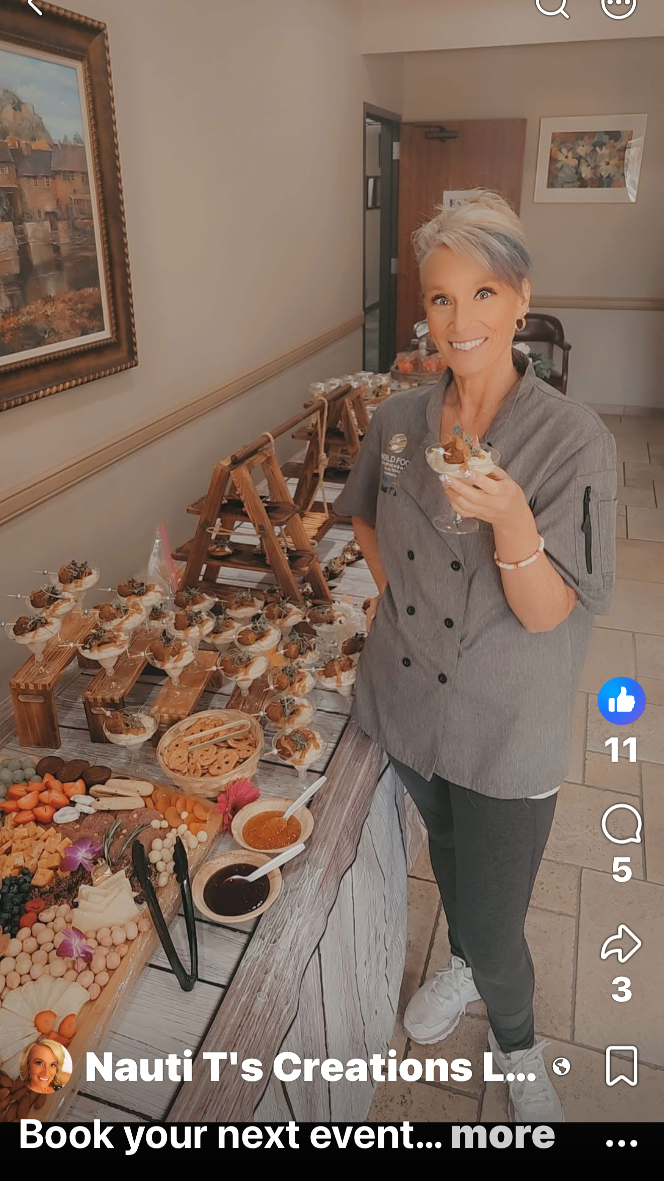 Nauti T's Creations catering and gourmet shop .She is standing in front of a table with assorted desserts and snacks.