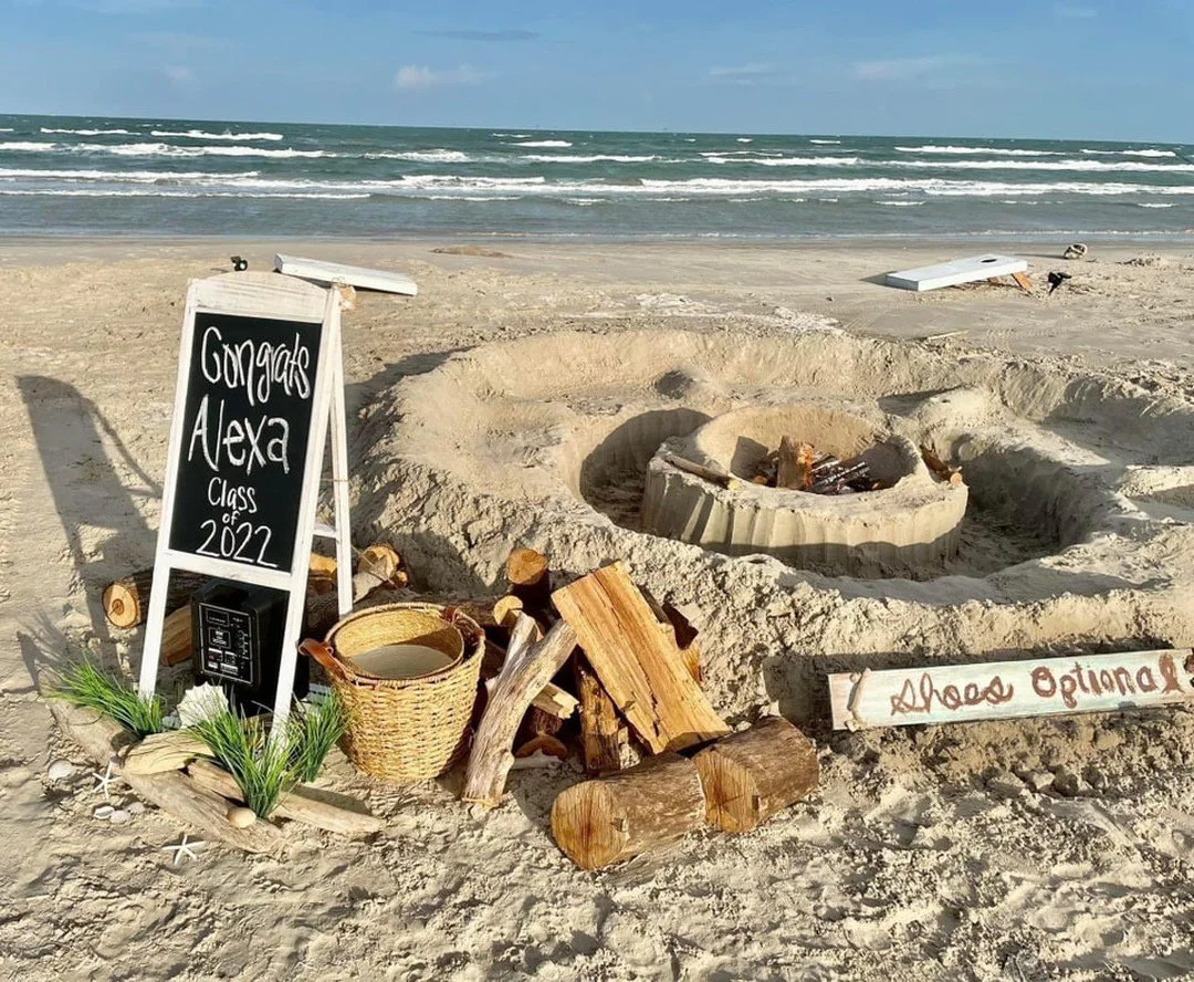 A beach scene showing a sand fire pit on whitecap beach, Padre Island TX