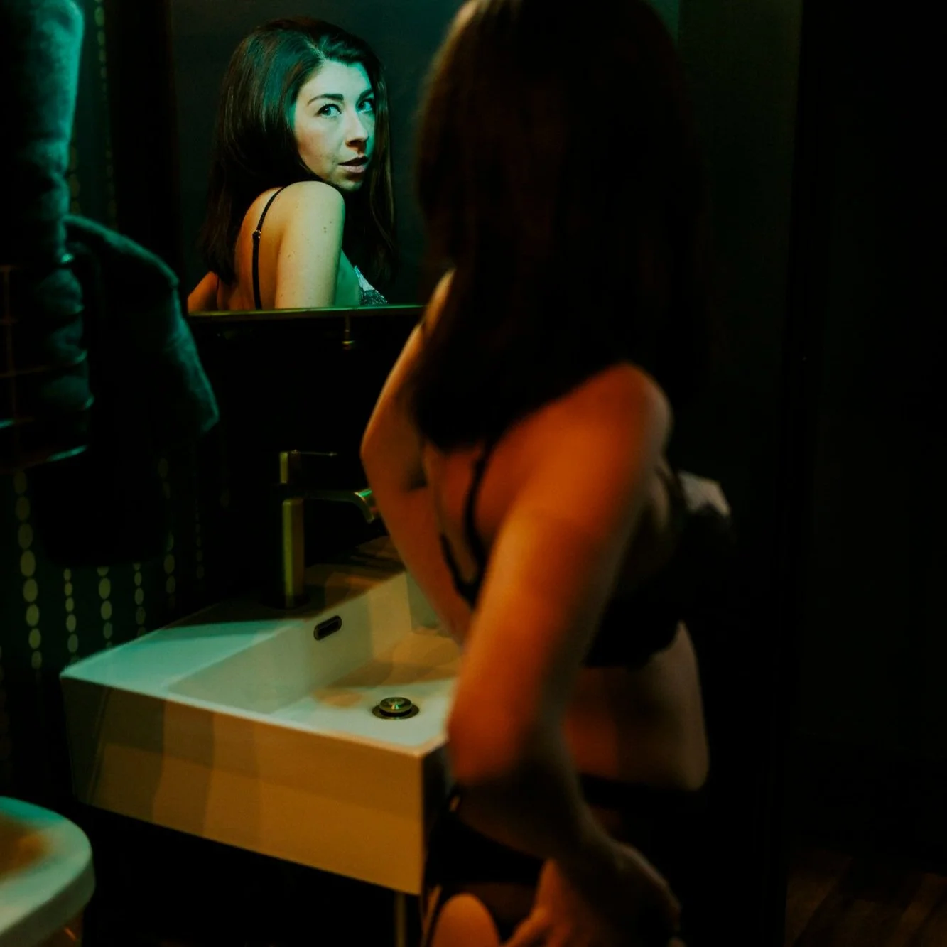 boudoir portrait woman's face in mirror reflection in bathroom 