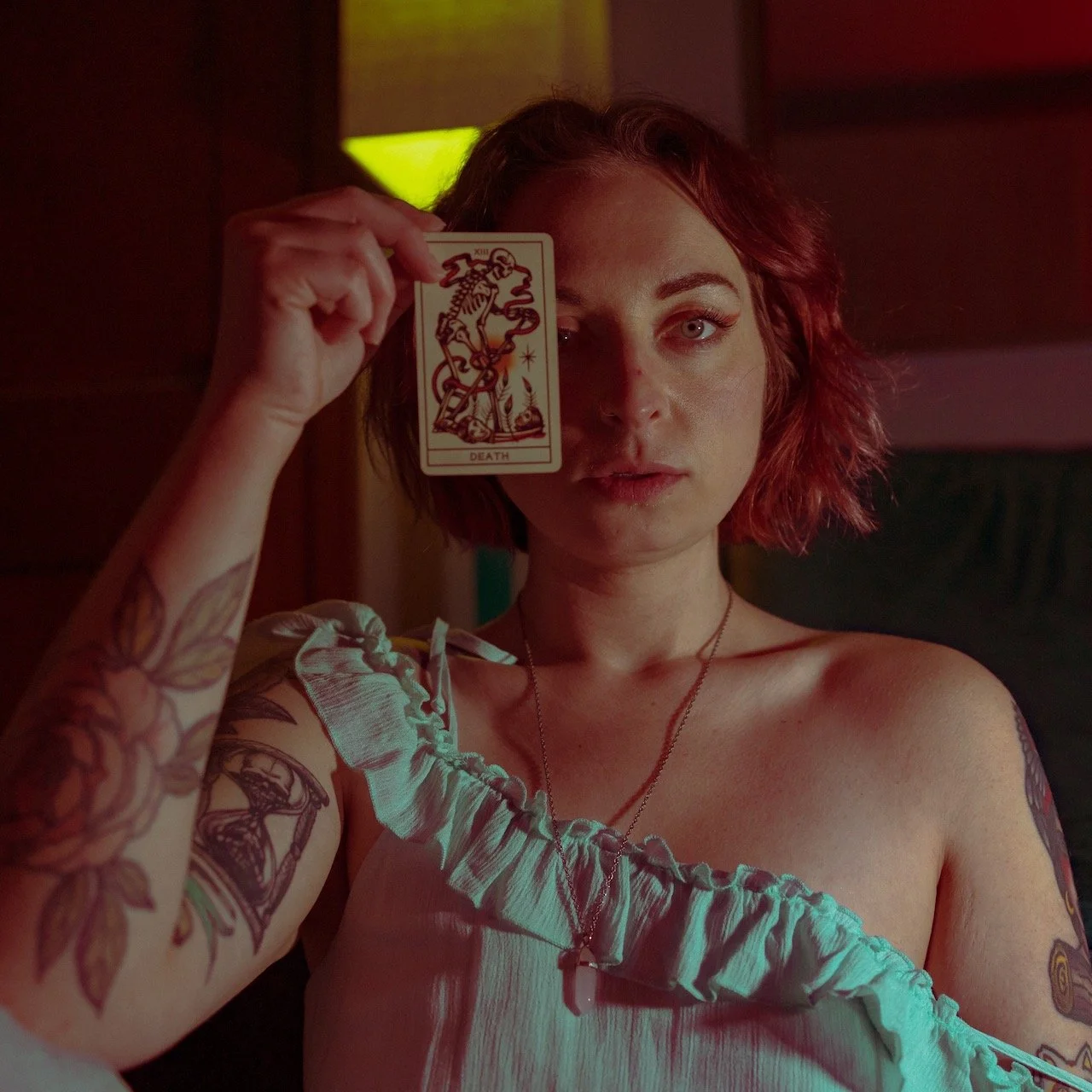 self-portrait wearing blue dress holding death tarot card 