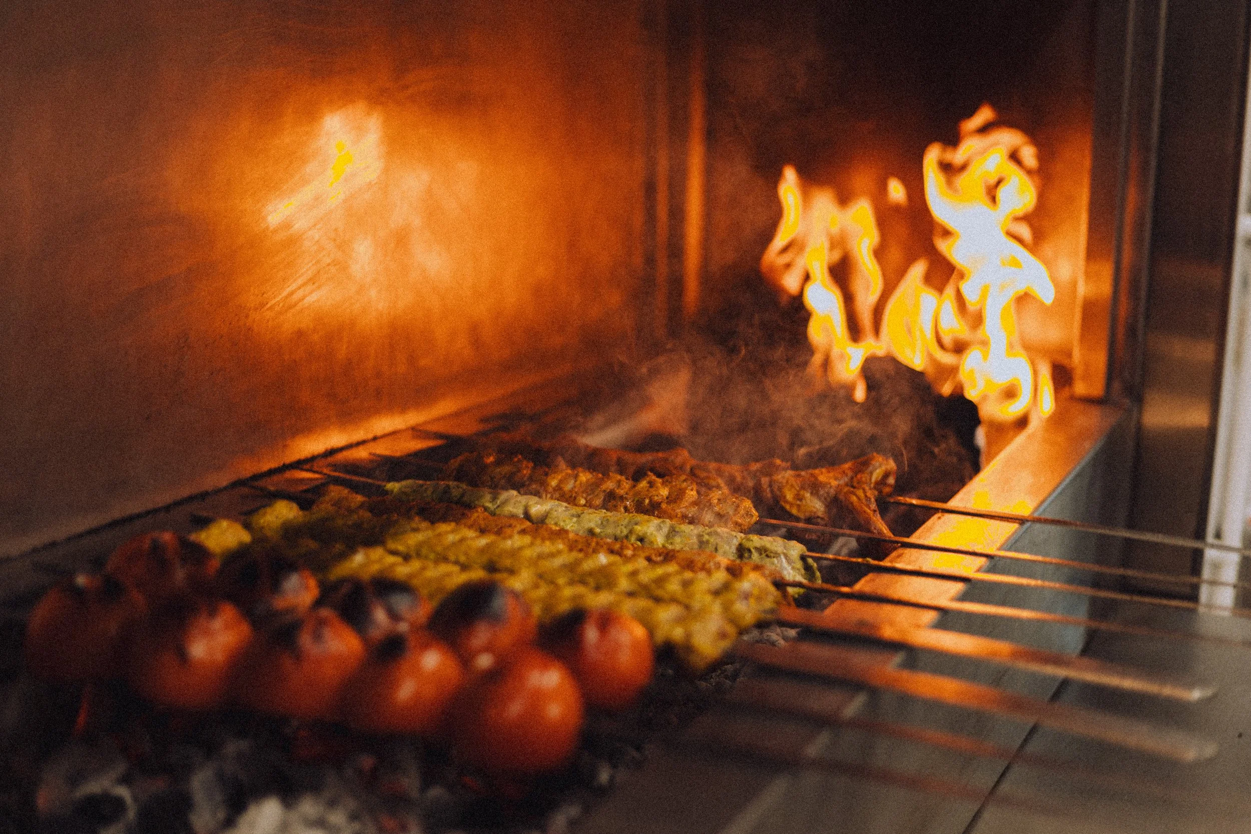 A selection of authentic Persian Mezze dishes served on elegant metal plates at Baba's Mezze, including creamy hummus with black truffle Olivieh, vibrant dips, and crispy felafel.