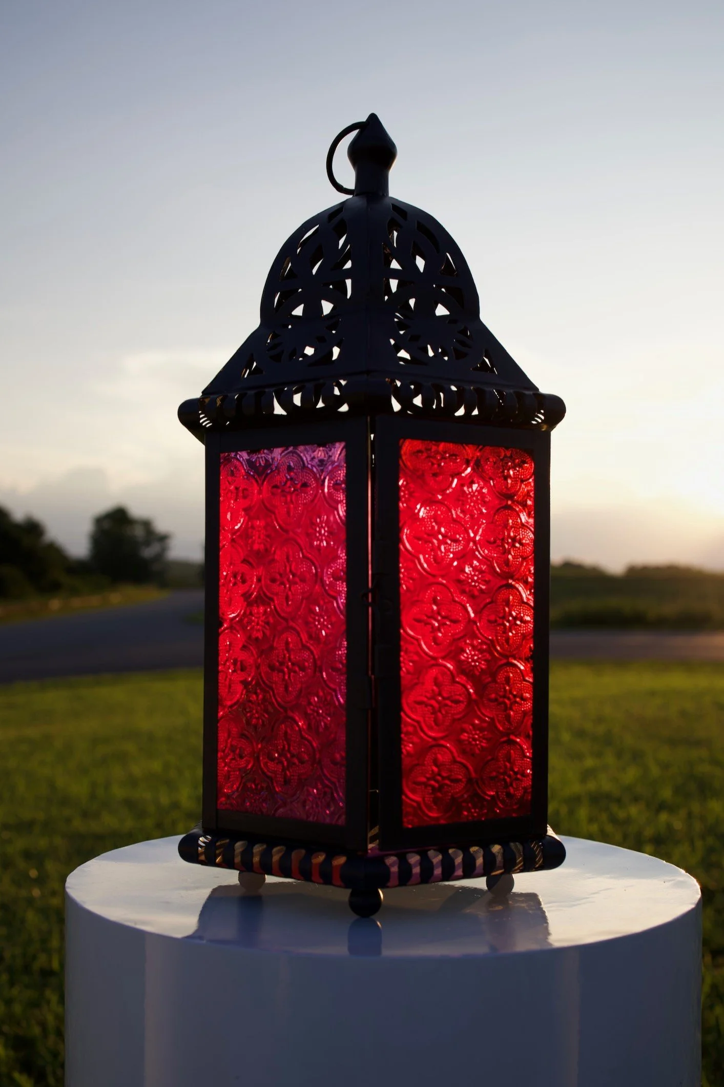 Black metal lantern with red, textured glass