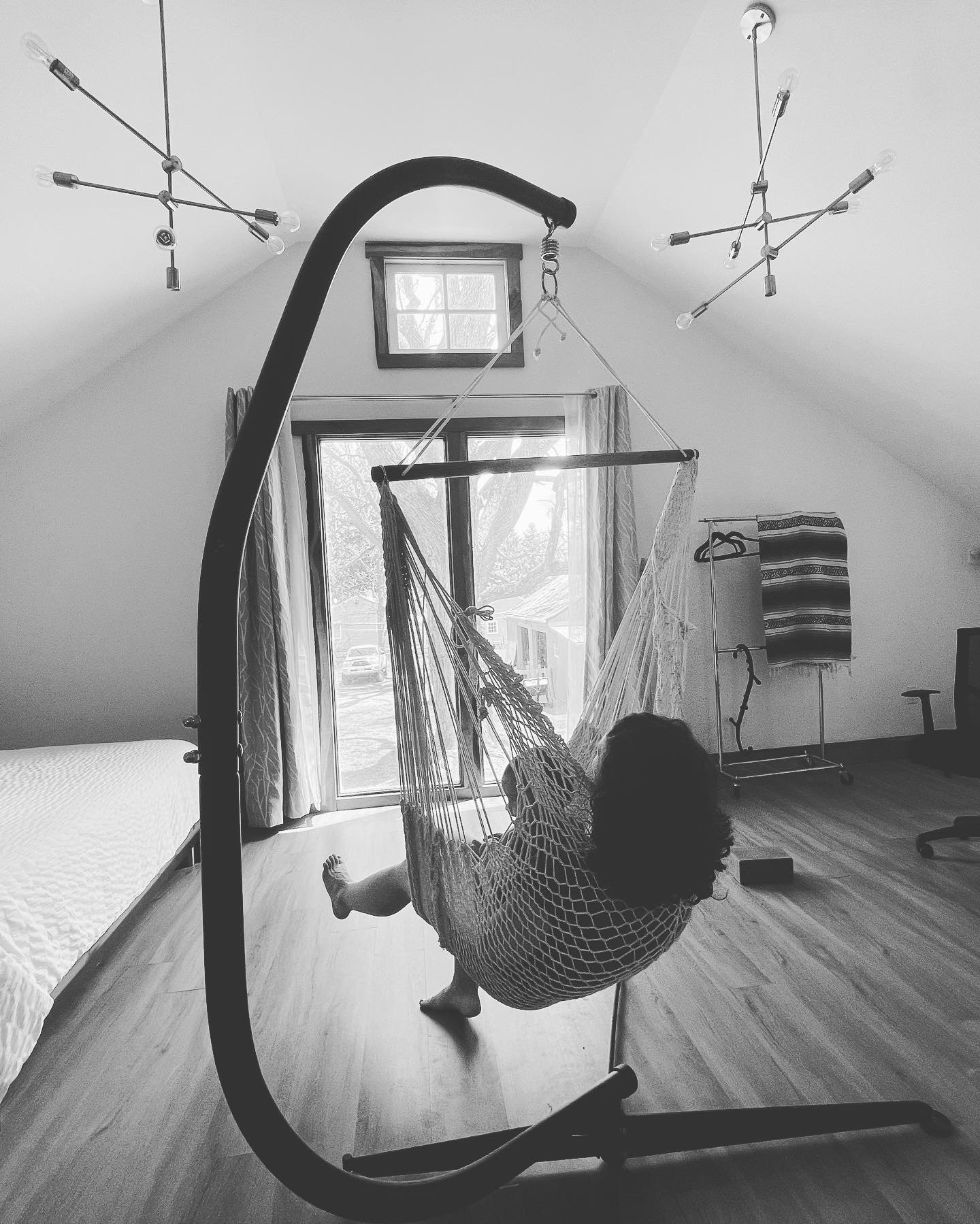 The hanging chair in the upper loft at Barn Manor