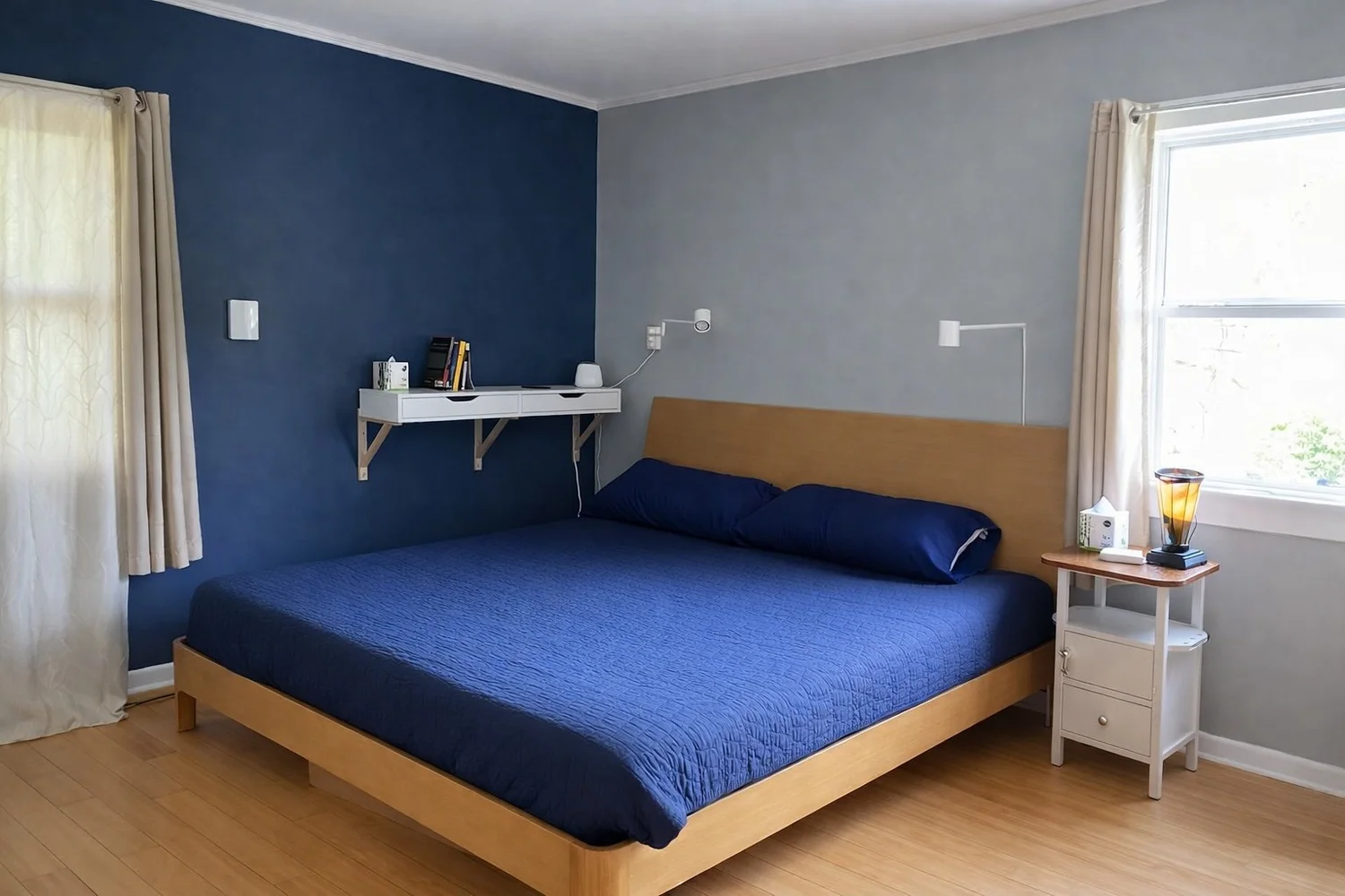 The master bedroom at Farm Manor with a king bed and blue wall