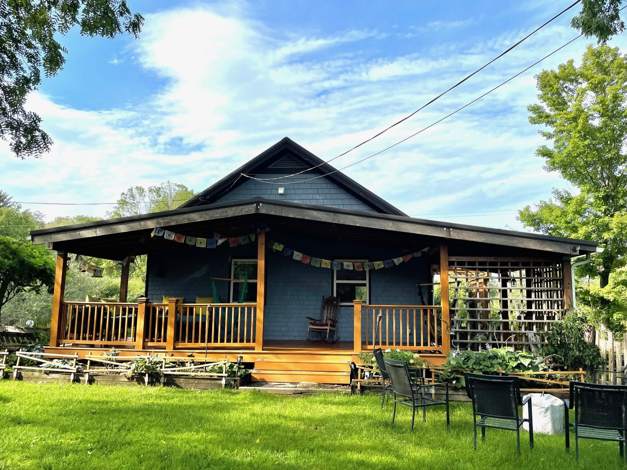 Farm Manor, the blue farmhouse with its covered porch and prayer flags