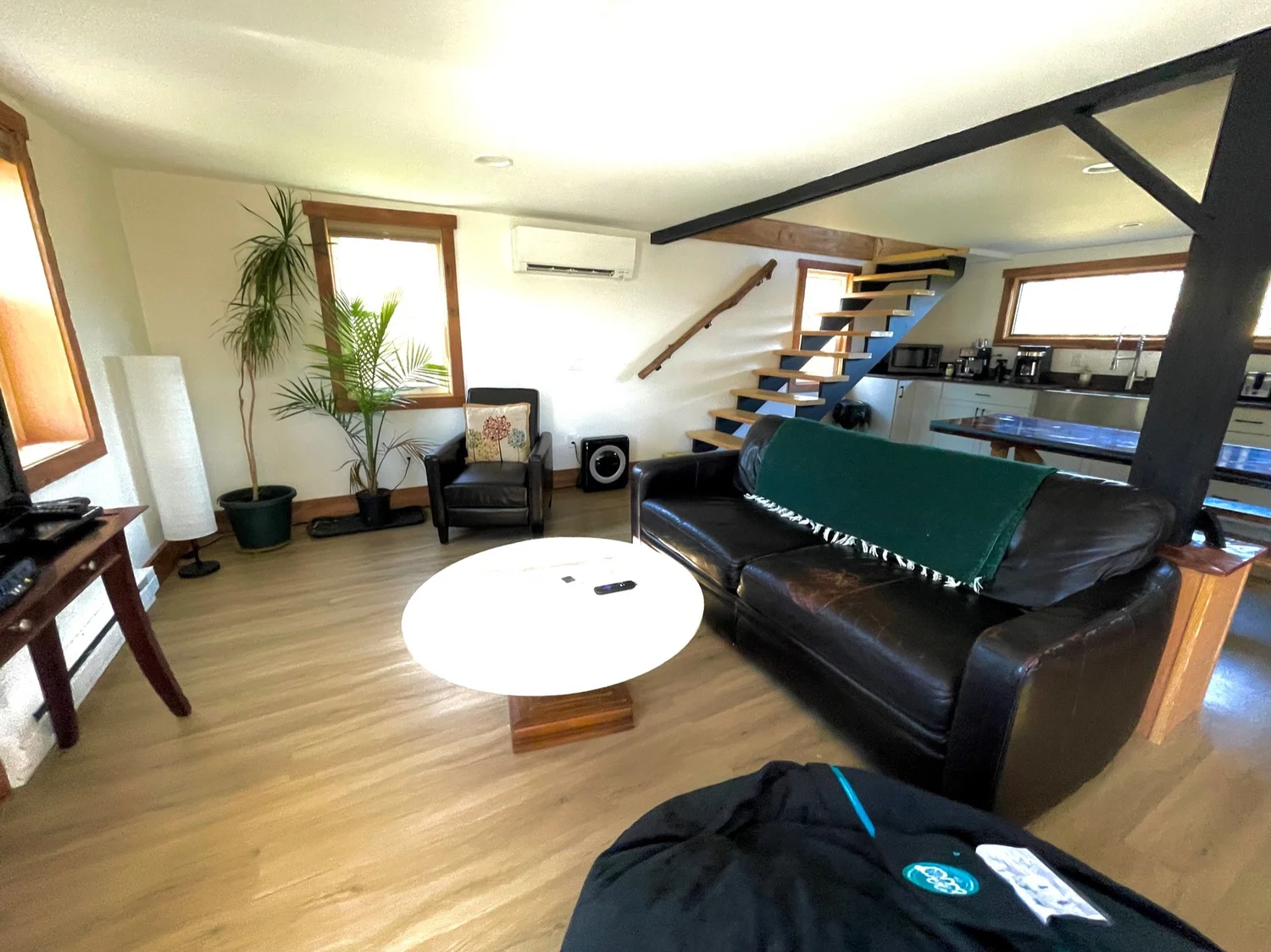 The open lower level of Barn Manor with the black steel stair