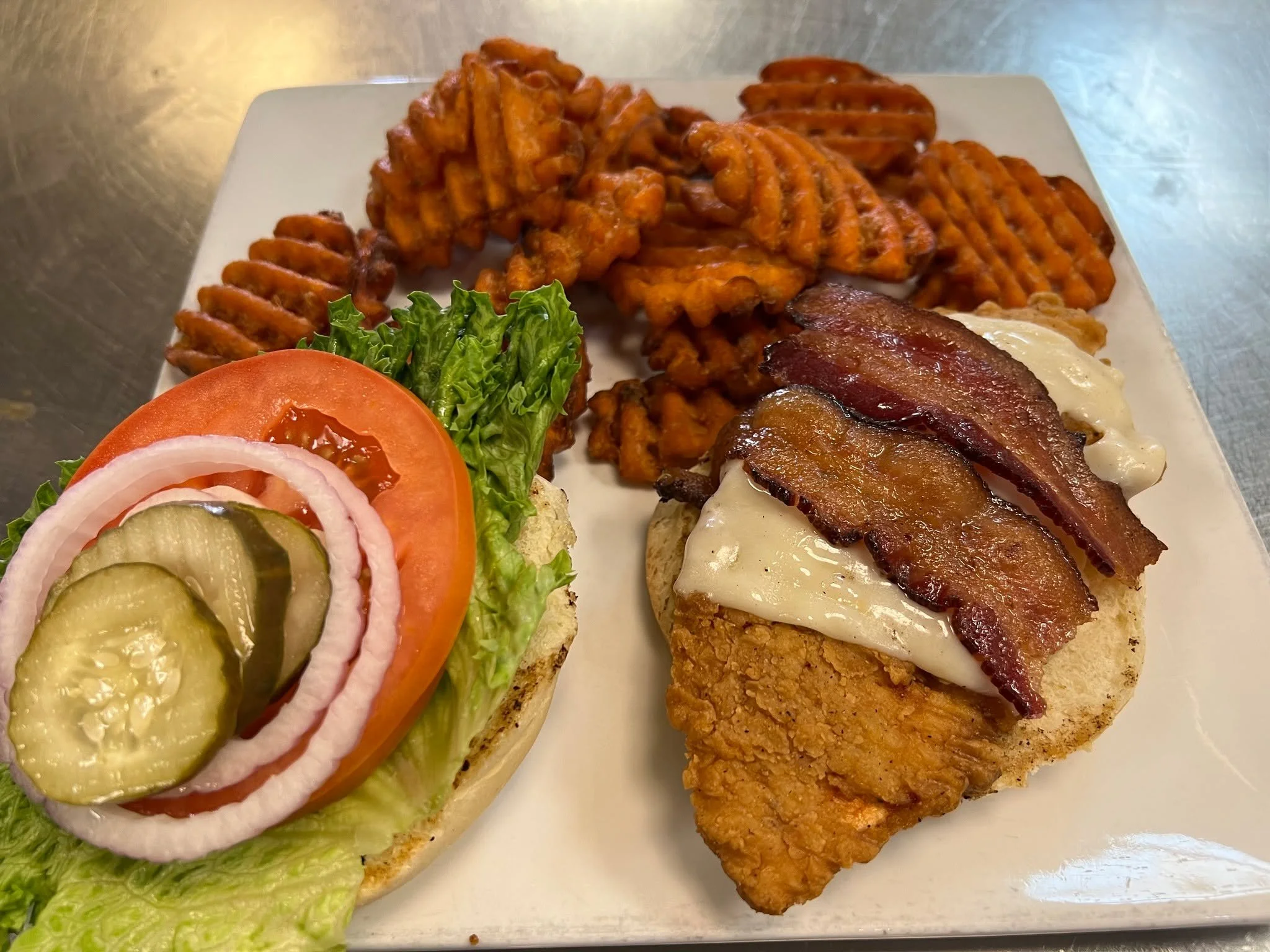 Sink your teeth into the ultimate combination of crunch and flavor with the Crispy Chicken Ranch sandwich. That side of sweet potato waffle fries seals the deal! We're serving up lunch until 2 PM. 😋

#Elkodreez #explorenevada #familyrunbusiness #foo