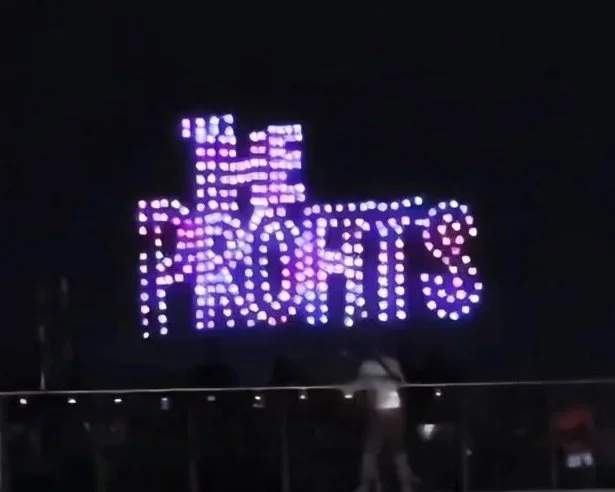 The Profits: Hundreds of drones form 'THE PROFITS' logo in the night sky during a live performance by The Profits.