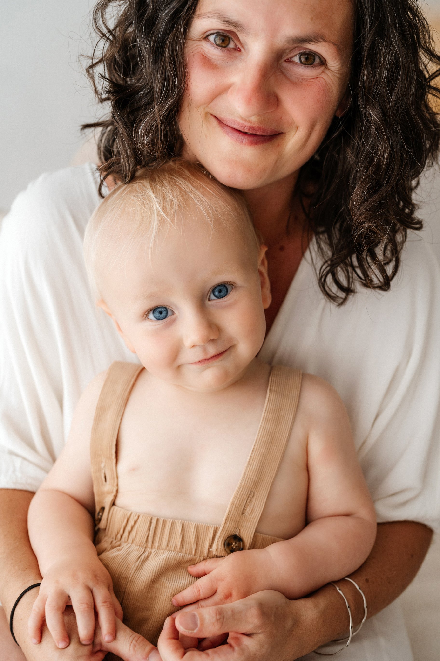 Sunshine Coast family photographer captures mother and child together in the beautiful white studio setting.