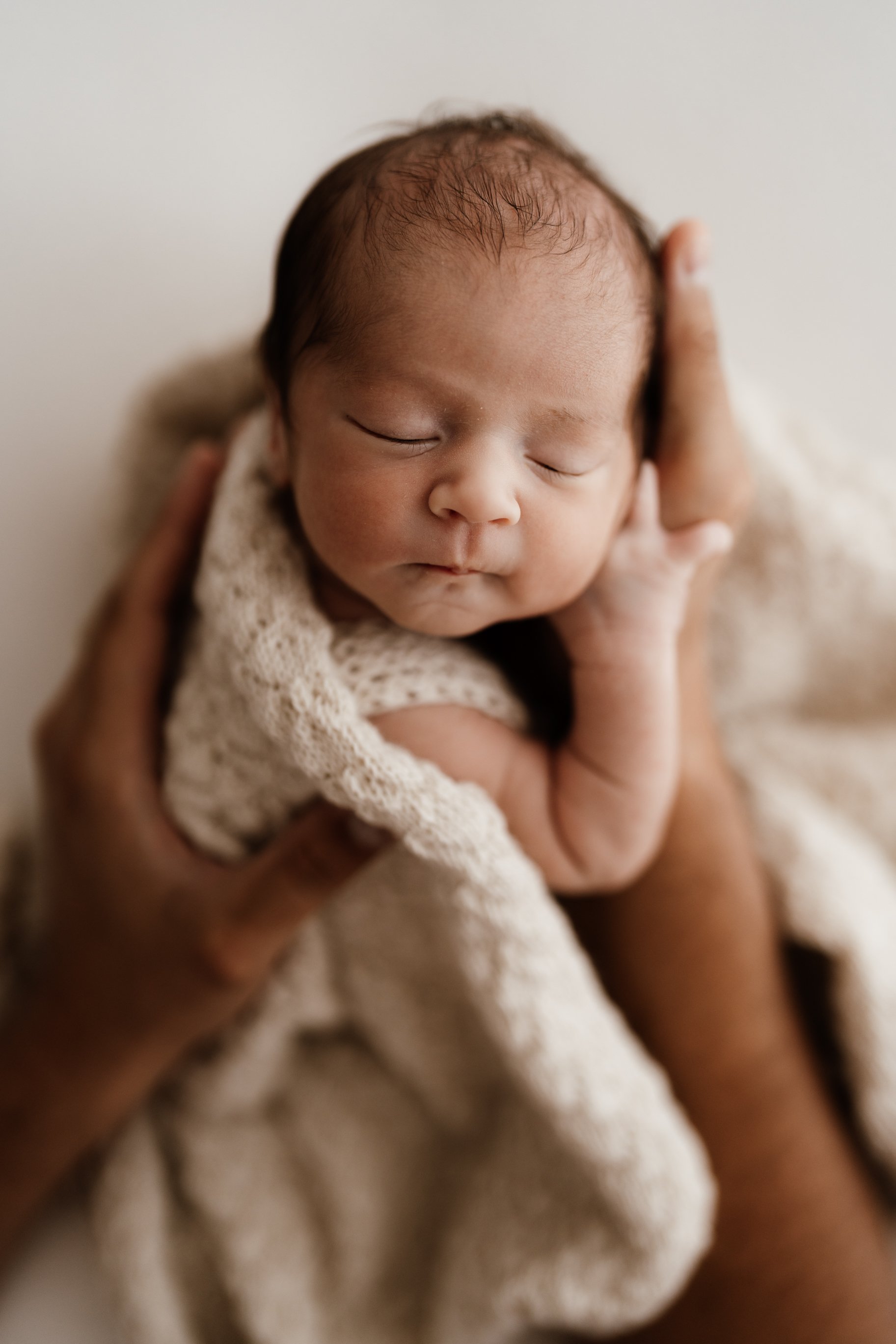 Sunshine Coast newborn photographer captures new baby during newborn photography shoot in the studio.
