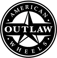 Black circular logo with a white border, featuring the text 'American Outlaw Wheels' and a stylized star with a compass needle in the center.