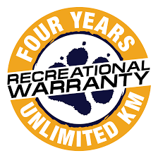 Four-year recreational warranty badge with gold and black colors, featuring a mountain and ski scene.