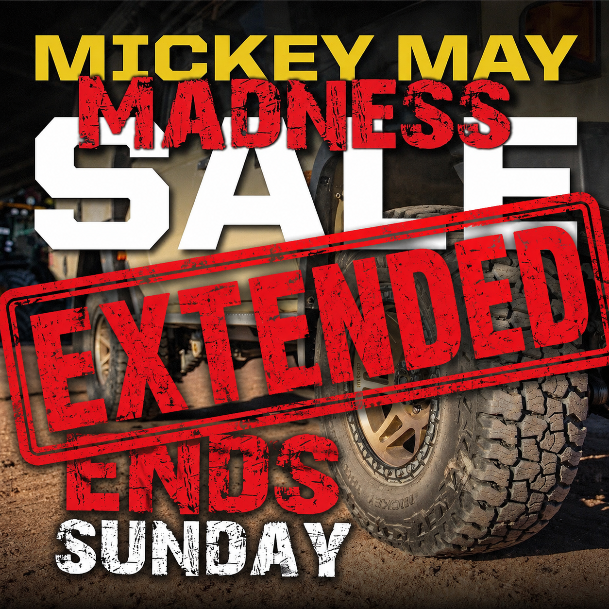 A promotional poster featuring a large off-road vehicle with chunky tires in the background. The poster has bold text announcing a sale event with the words "Mickey May Madness Sale" in yellow and red and a large red "Extende" stamp overlay.