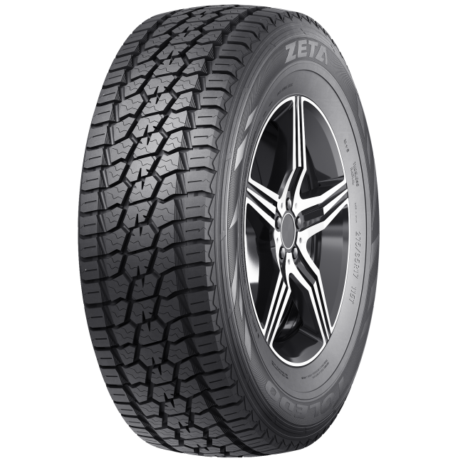 Close-up of a black all-terrain tire with a patterned tread, mounted on a modern alloy wheel with a five-spoke design, branded 'Zeta'.