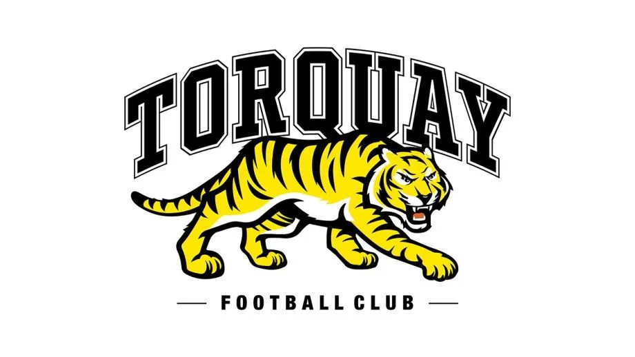 Logo of Torquay Football Club featuring a yellow tiger with black stripes, walking on all fours, with the text 'TORQUAY' above and 'FOOTBALL CLUB' below.