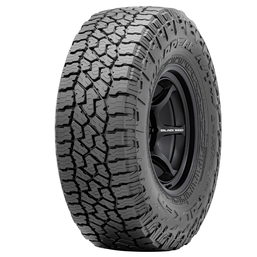 An all-terrain tire mounted on a black rim with the brand name Black Rhino.