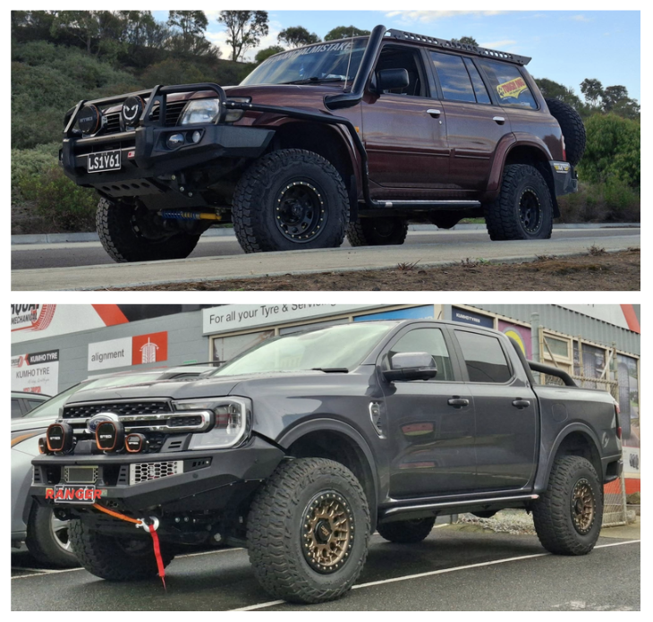 Two pickup trucks, one dark red off-road vehicle with large tires and a front brush guard, and one black truck with custom lights, off-road tires, and a winch mounted at the front.