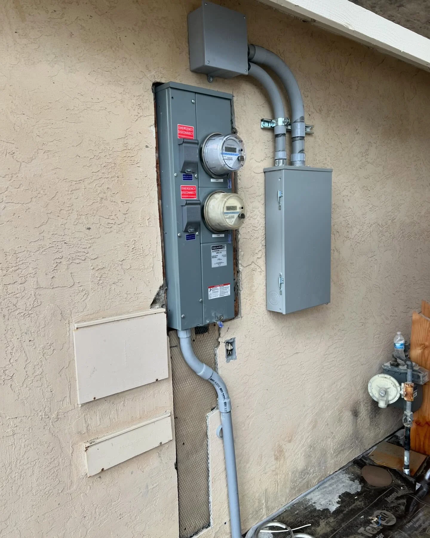 Second utility meter added for an ADU. Mounted load center for main house beside.