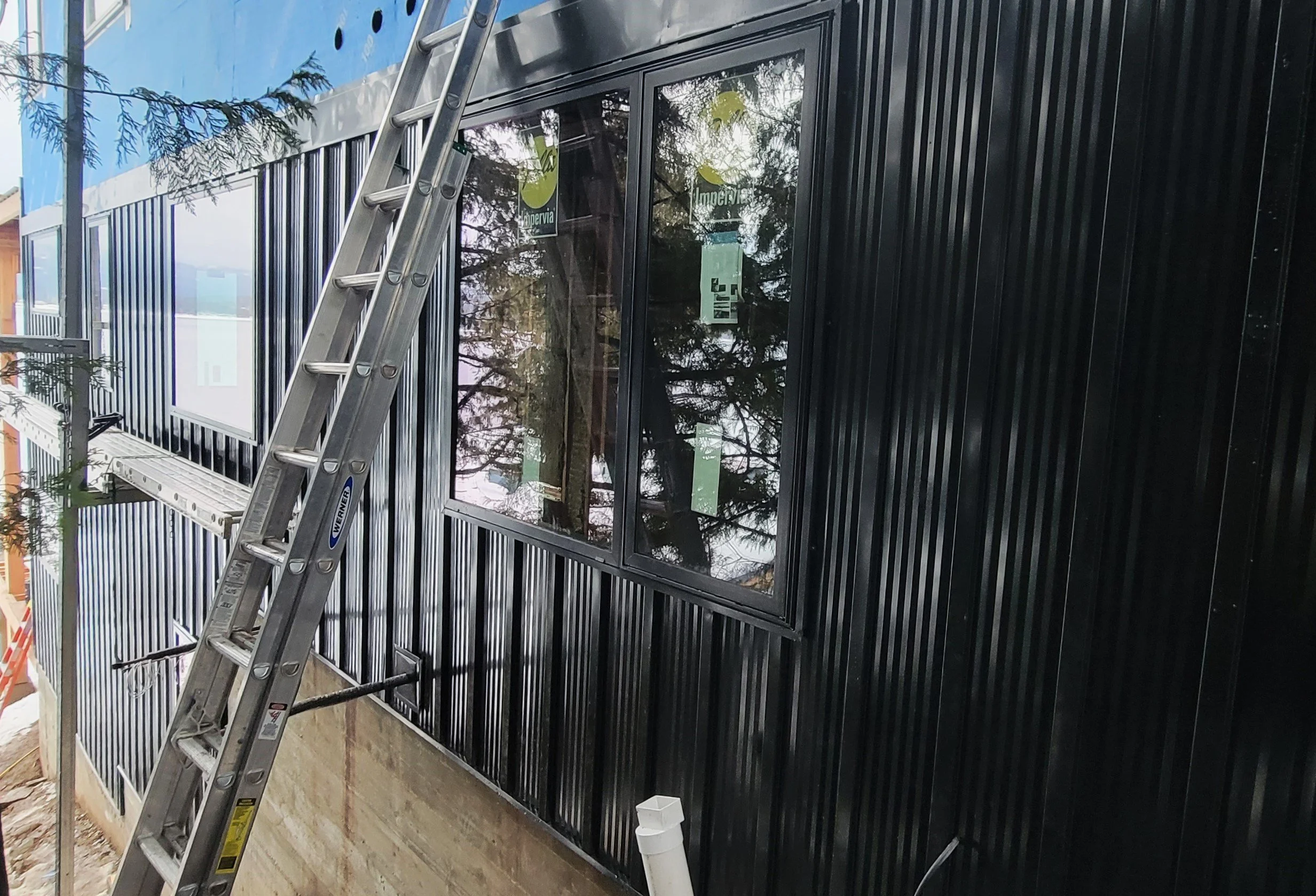 (During) Sheathing, Blueskin House Wrap, Window Installation, Metal Board & Batten Siding, Metal Soffit & Fascia