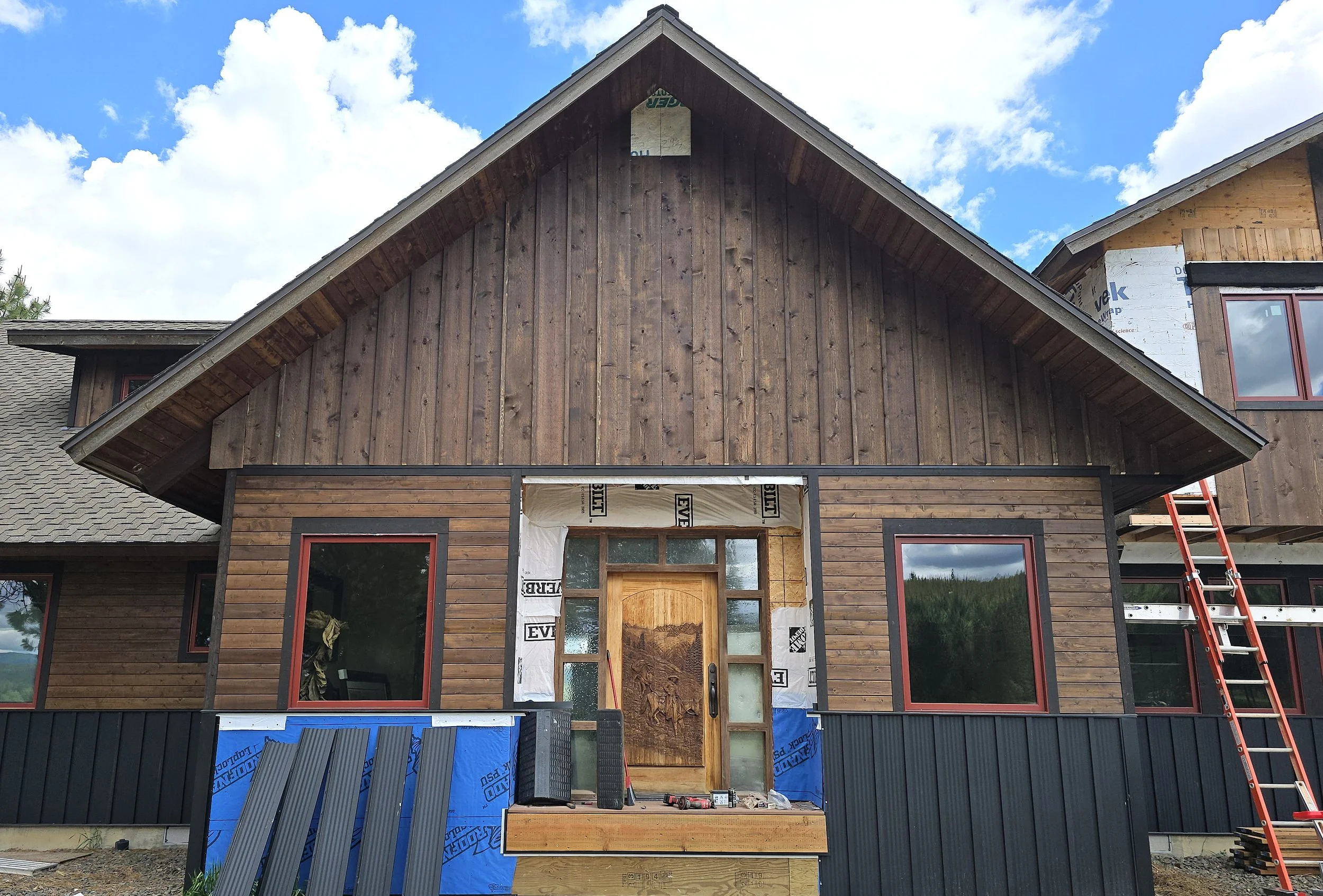 (During) Re-side: Cedar board and batten siding, cedar tongue and grove siding, cedar soffit, cedar trim, metal wainscoting replacements