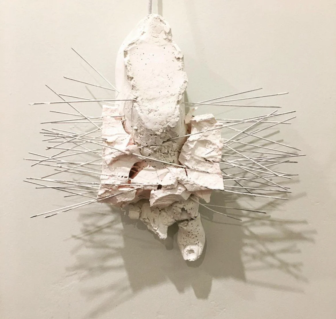 Mixed media sculpture of a foot with spikes