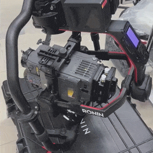 Close-up of a professional camera mounted on a stabilizer rig, with a monitor attached on the right side.