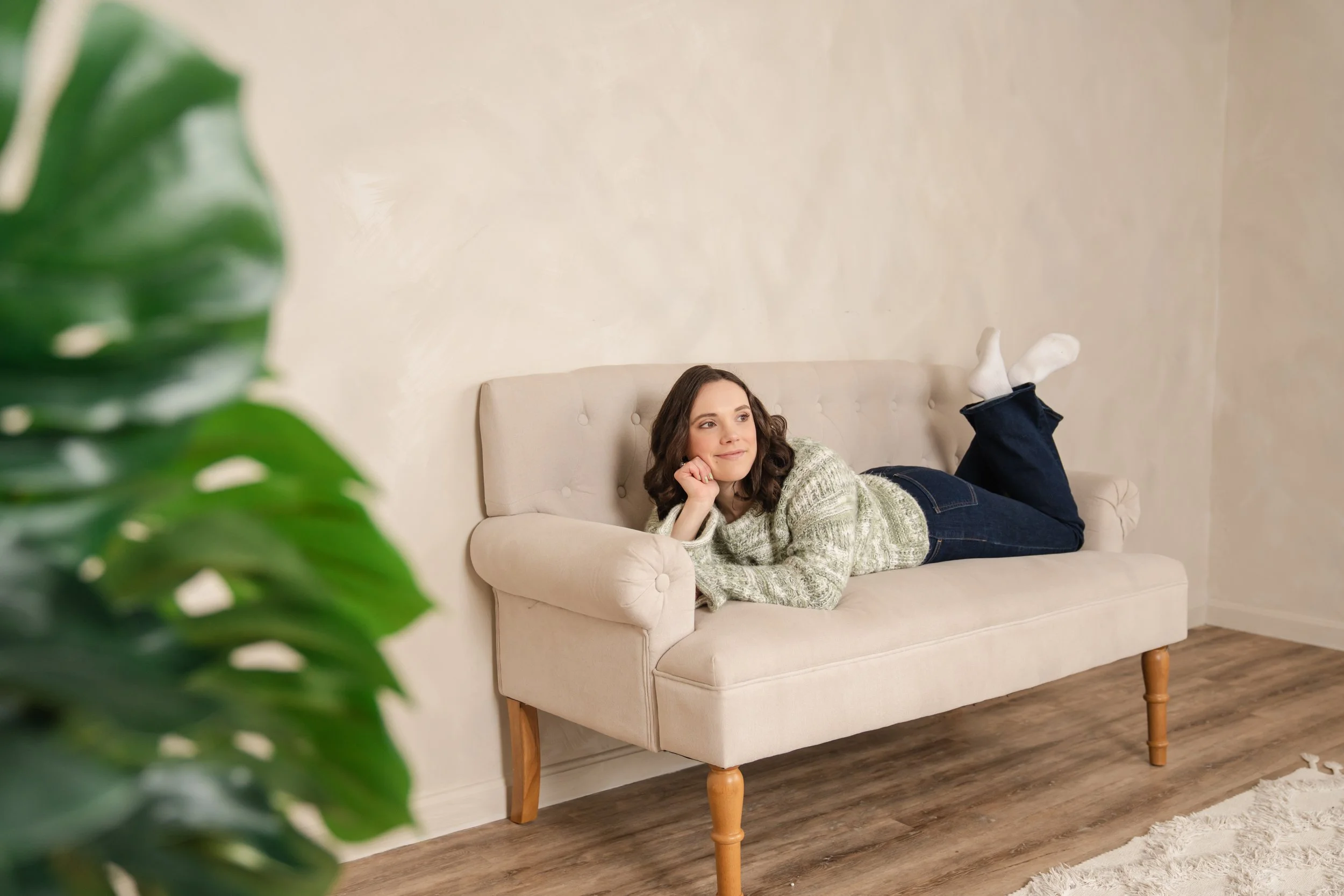 Bud to Bloom Marketing founder laying on a couch thinking