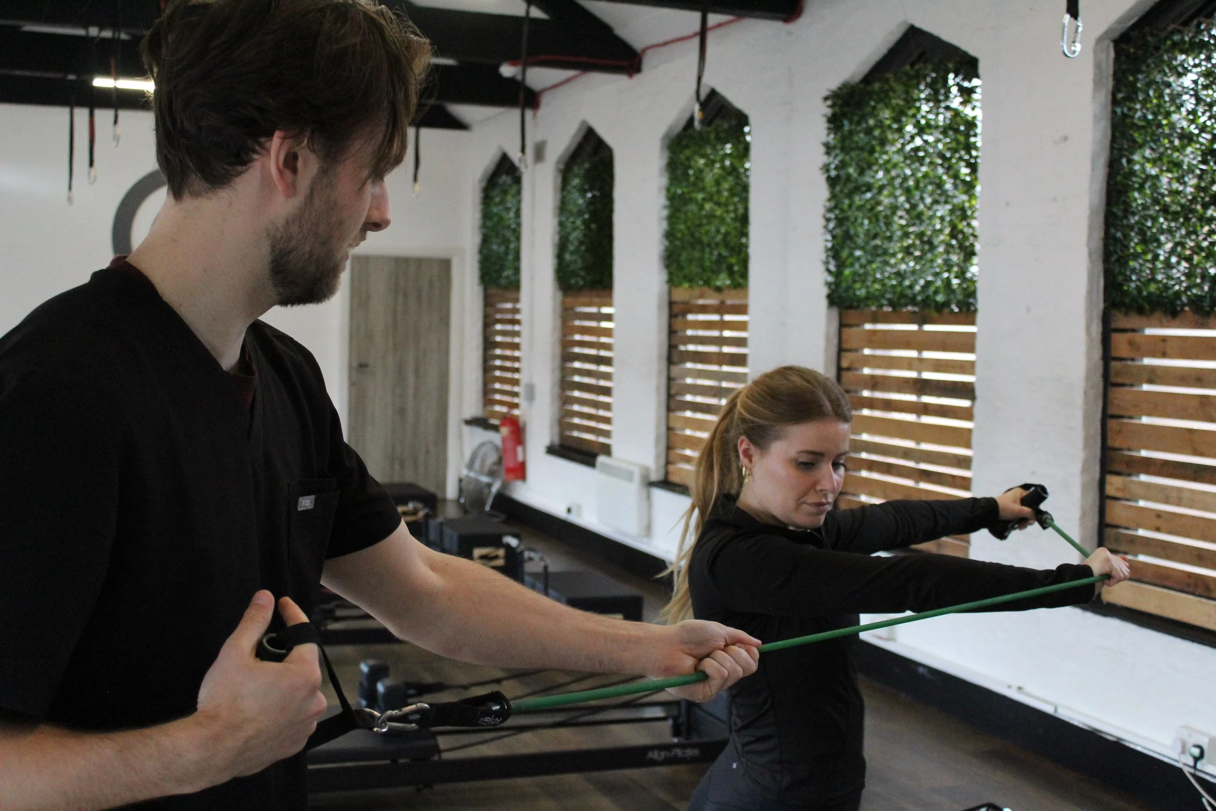 Physical therapist helping a person with resistance band exercises