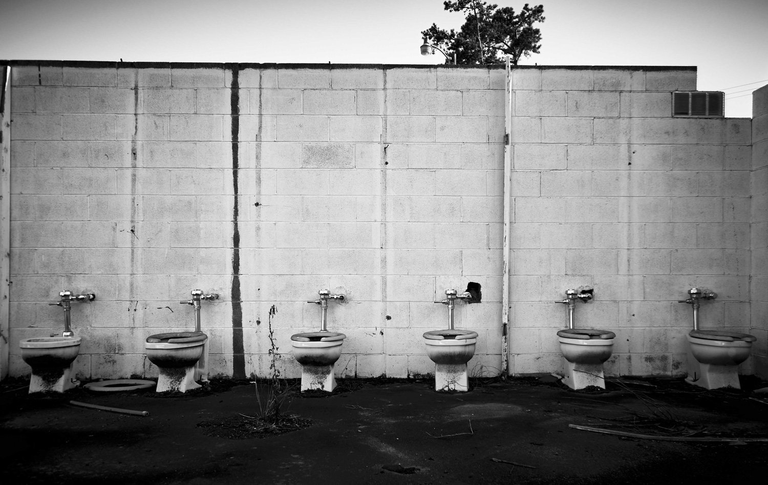 gritty-industrial-fine-art-documentary-outdoor-toilets-cinder-wall-by-kip-dawkins