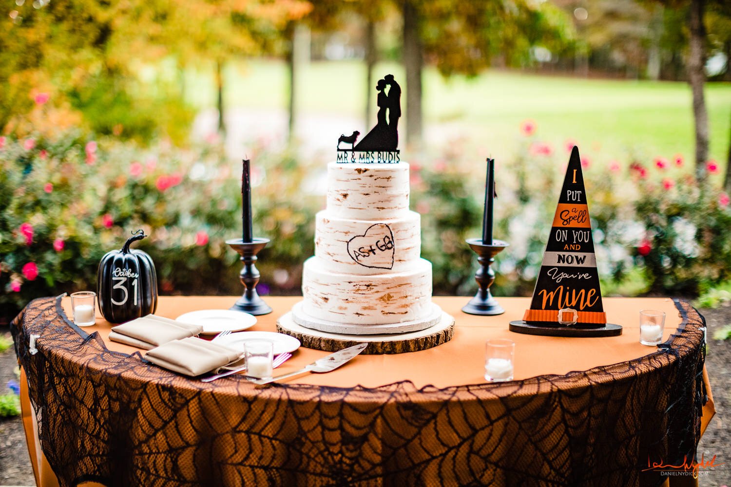 halloween nj wedding cake table with candles and pumpkins