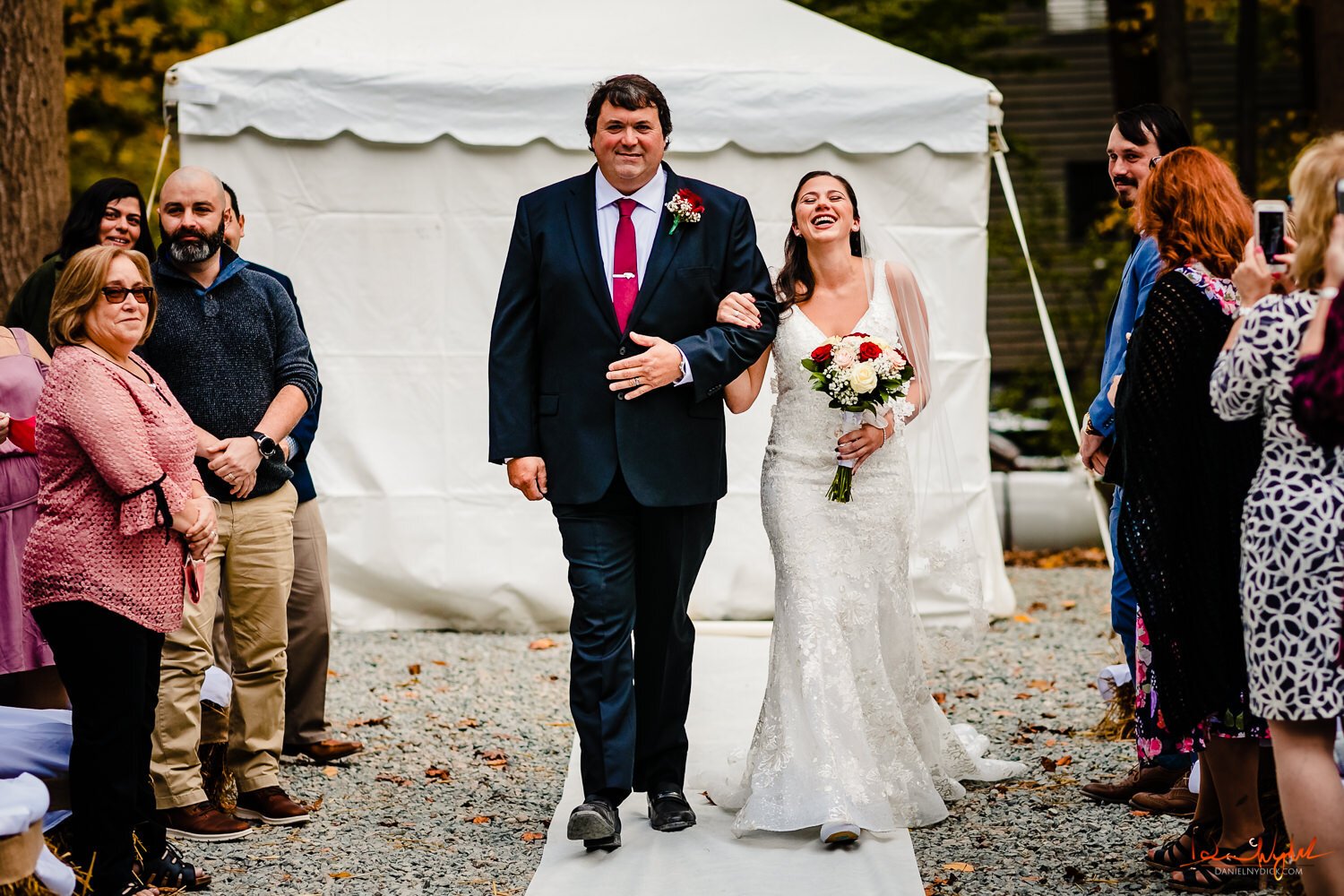 bride laughing walking down the aisle with dather nj rustic barn