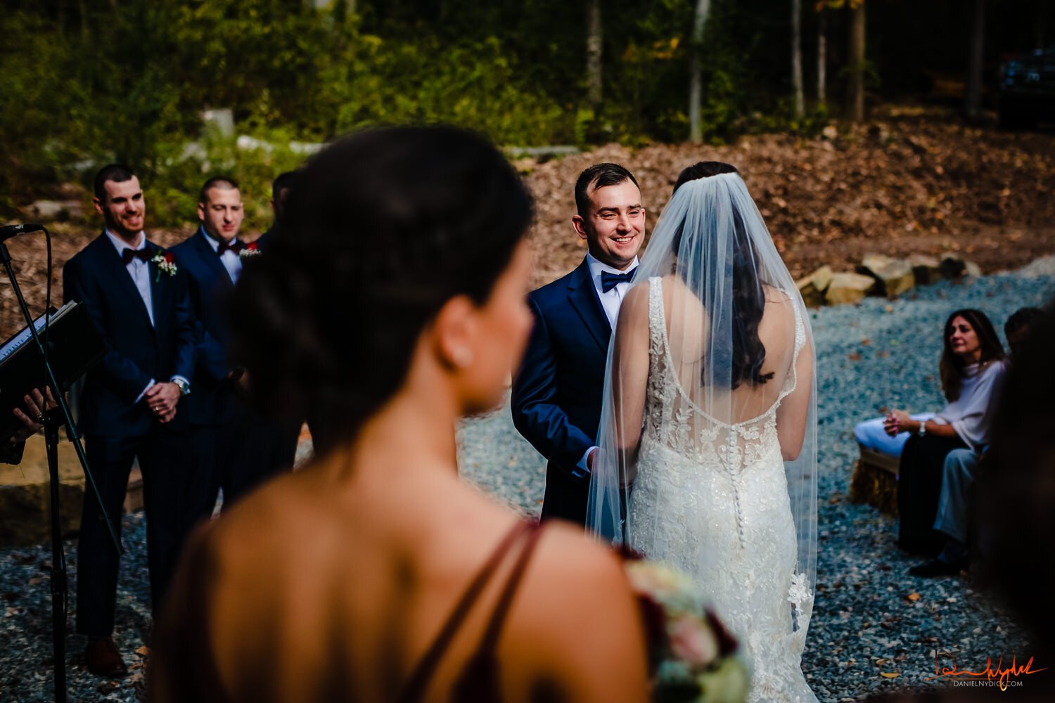 groom smiling while holding brides hand nj wedding barn