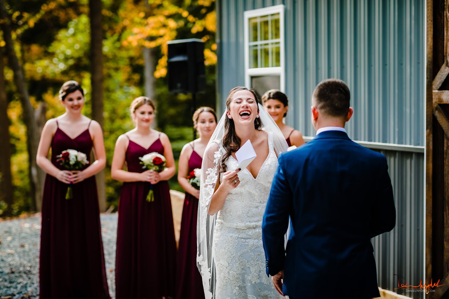 bride laughing while getting married nj barn wedding