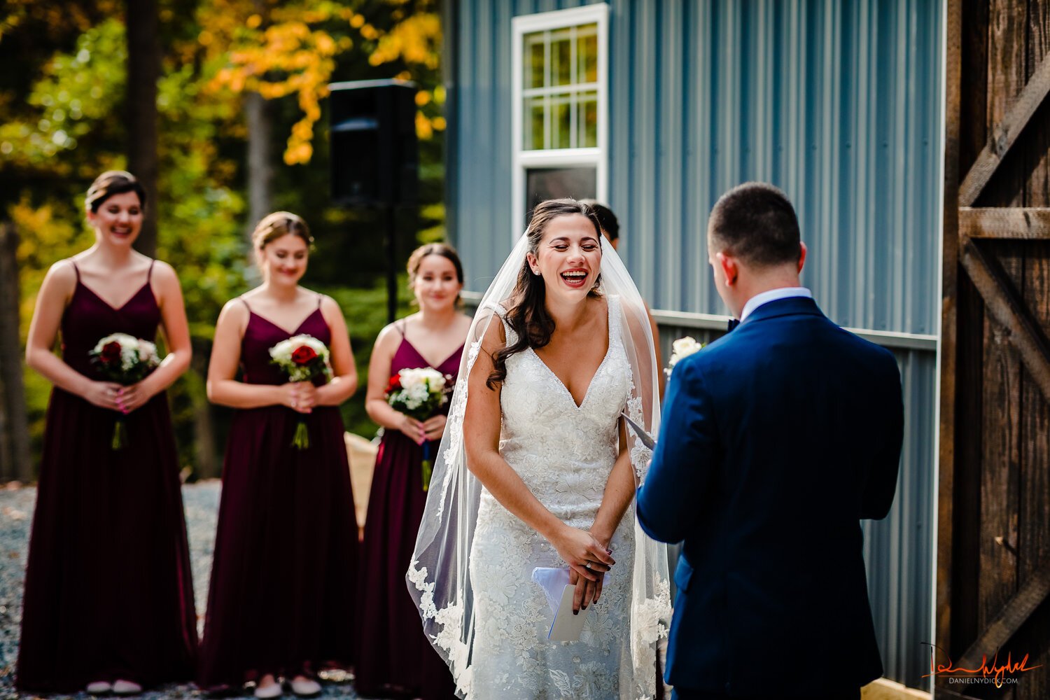 bride laughing while getting married nj barn wedding
