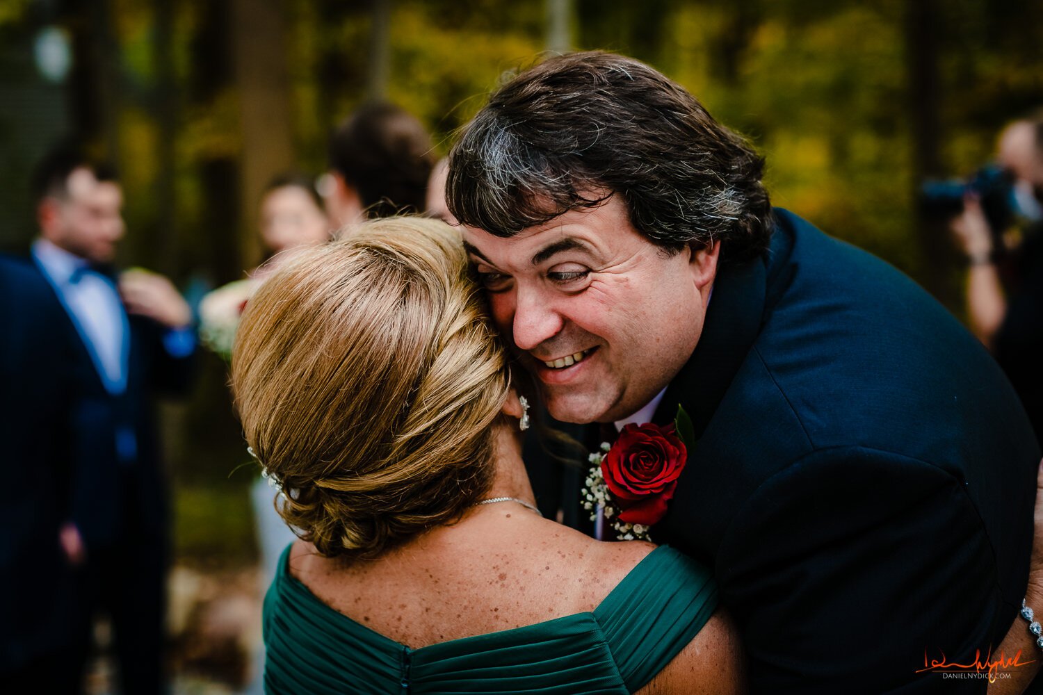 father hugging mother of the groom nj rustic barn wedding