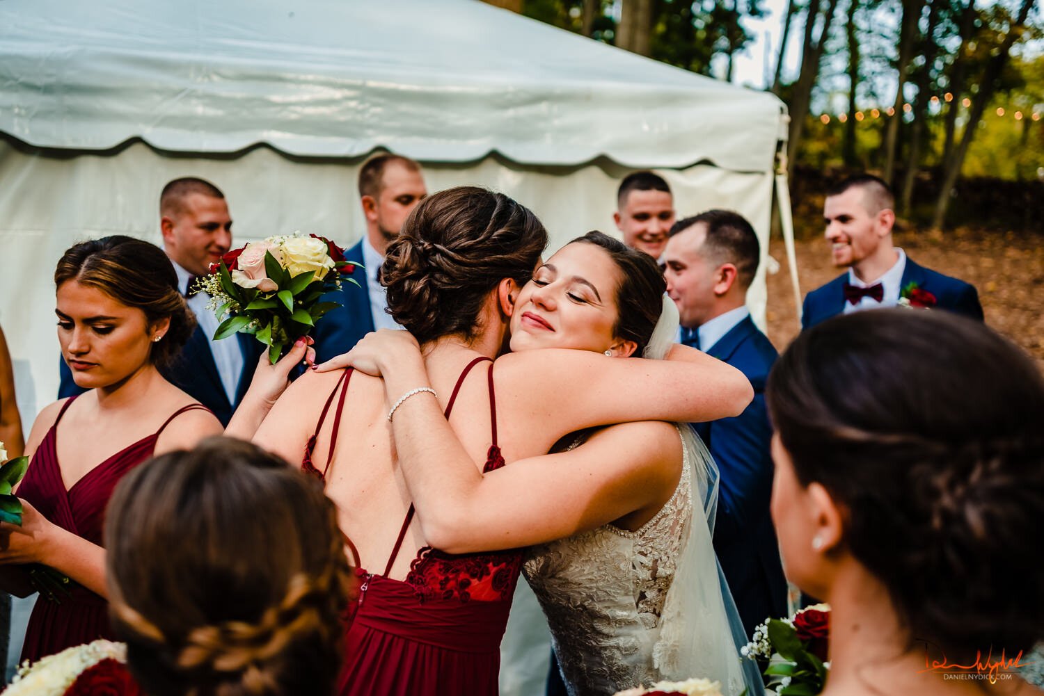 bride hugging bridesmaid after wedding rustic barn nj