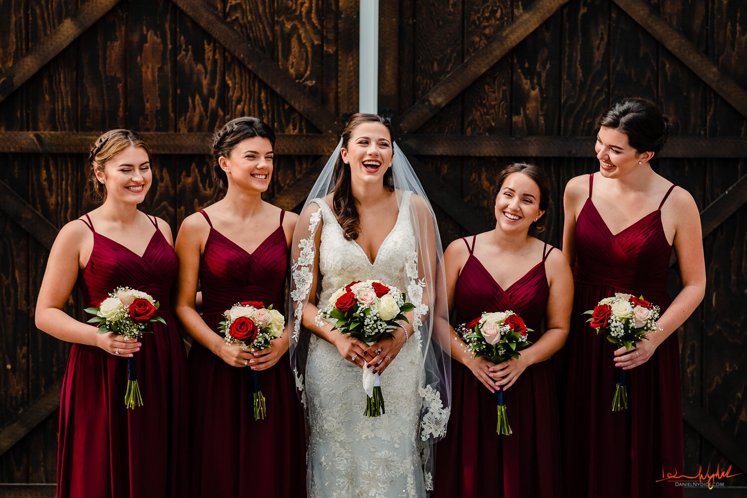 bride laughing with bridesmaids nj rustic wedding barn