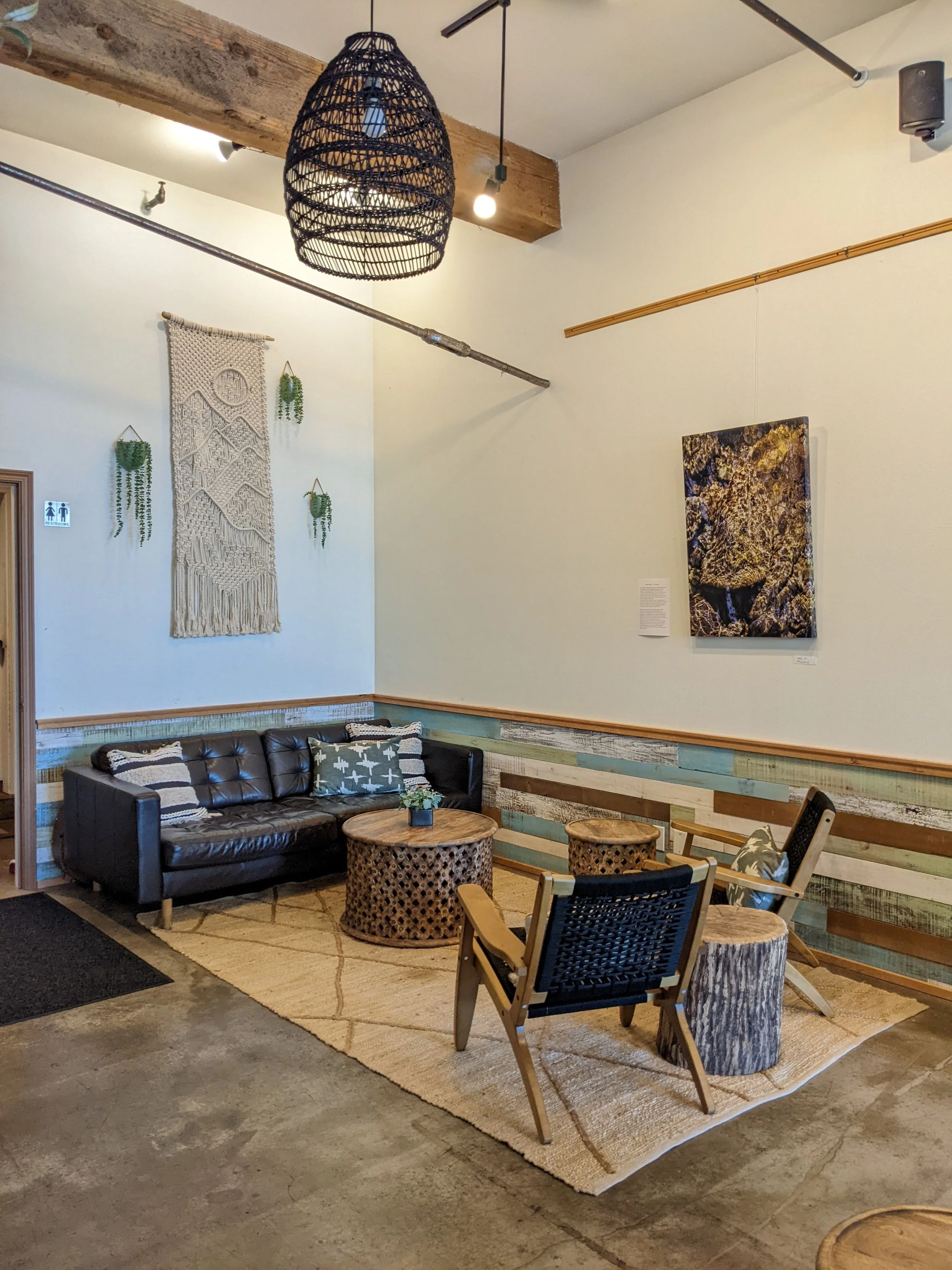 Integrated new furniture selections with old and painted cafe walls white to highlight the local artist gallery. 