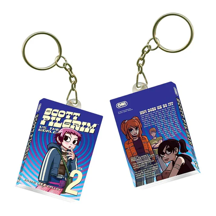 Two keychains featuring characters from the animated TV show 'Scott Pilgrim vs. the World.' One keychain shows a girl with pink hair and a hoodie, and the other shows three girls, two with brown hair and one with black hair, all in colorful outfits.
