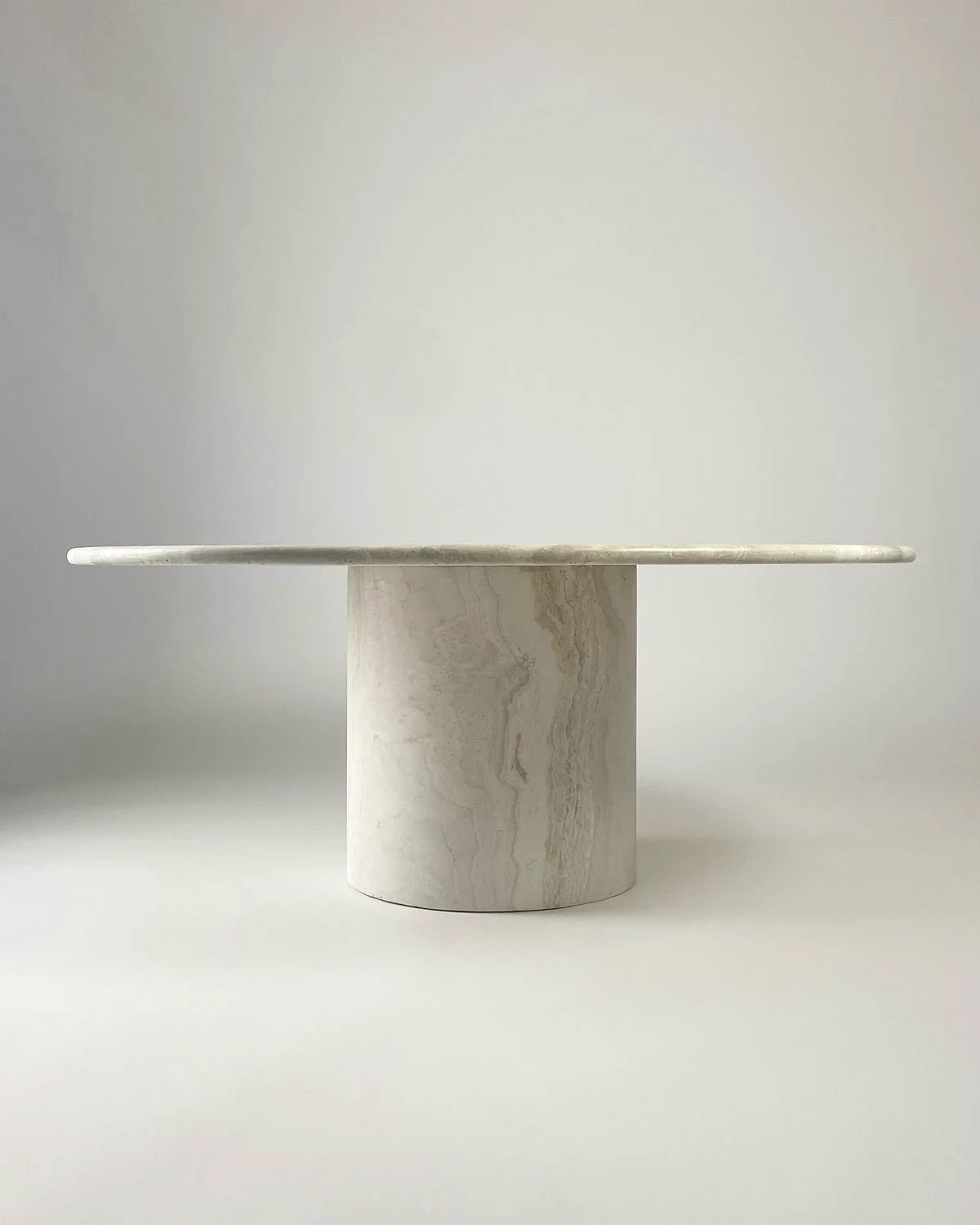 Distinguished Round Living Room Table
A statement of quiet elegance, where form meets timeless craftsmanship.

This round table, with its sculptural silhouette and noble stone surface, is more than furniture; it is a conversation piece, a place where