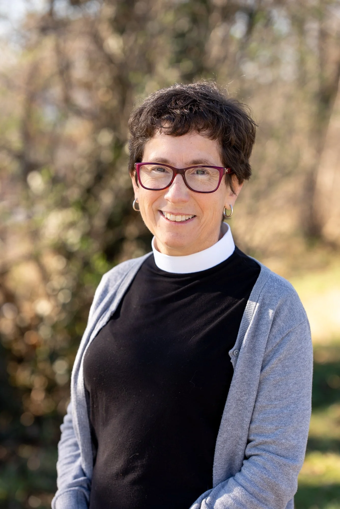 A woman wearing a black shirt smiling