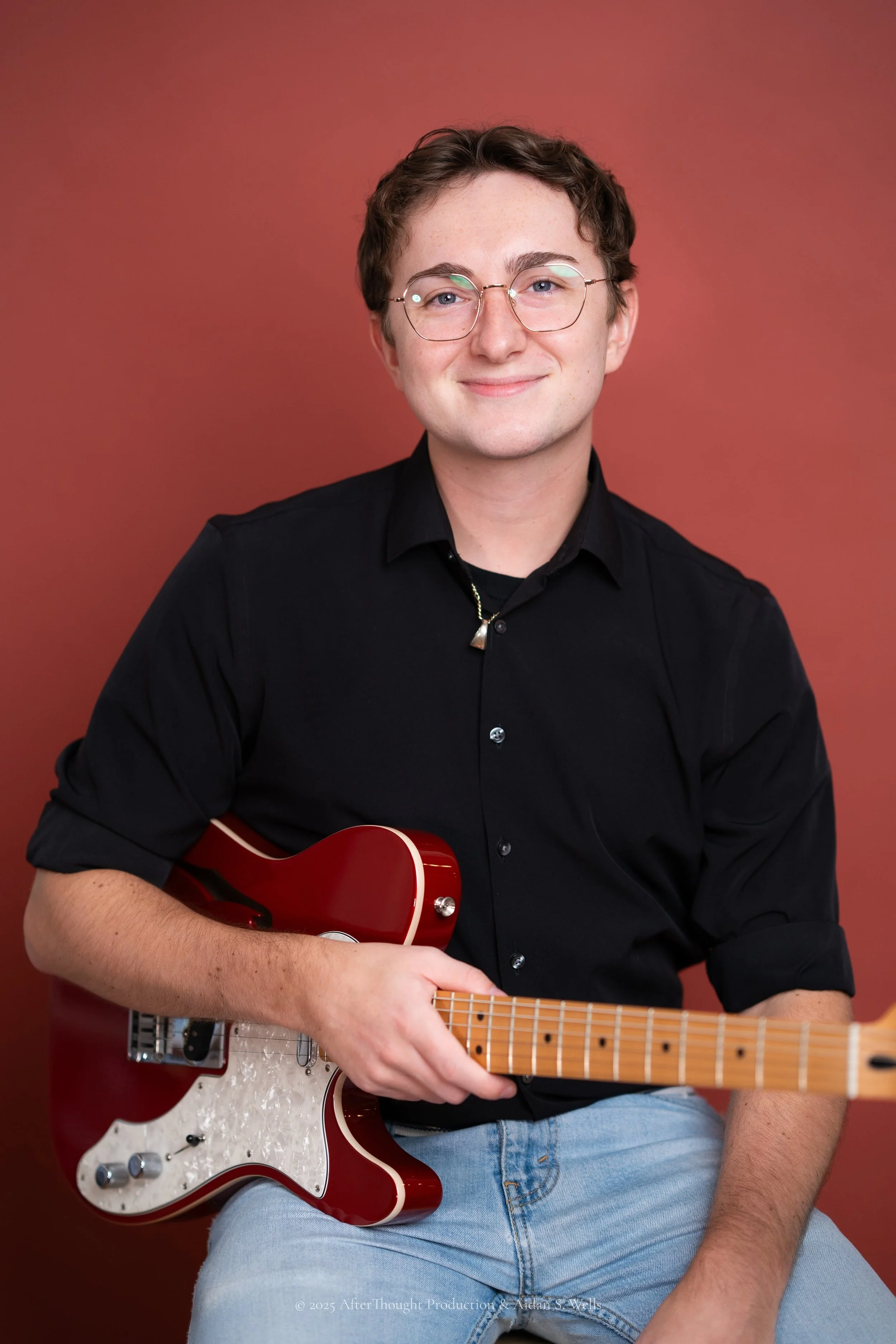 Man wearing a black button down t-shirt