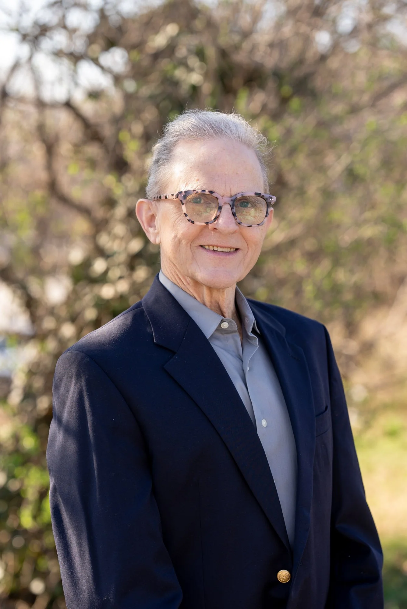 man in a blue suit smiling