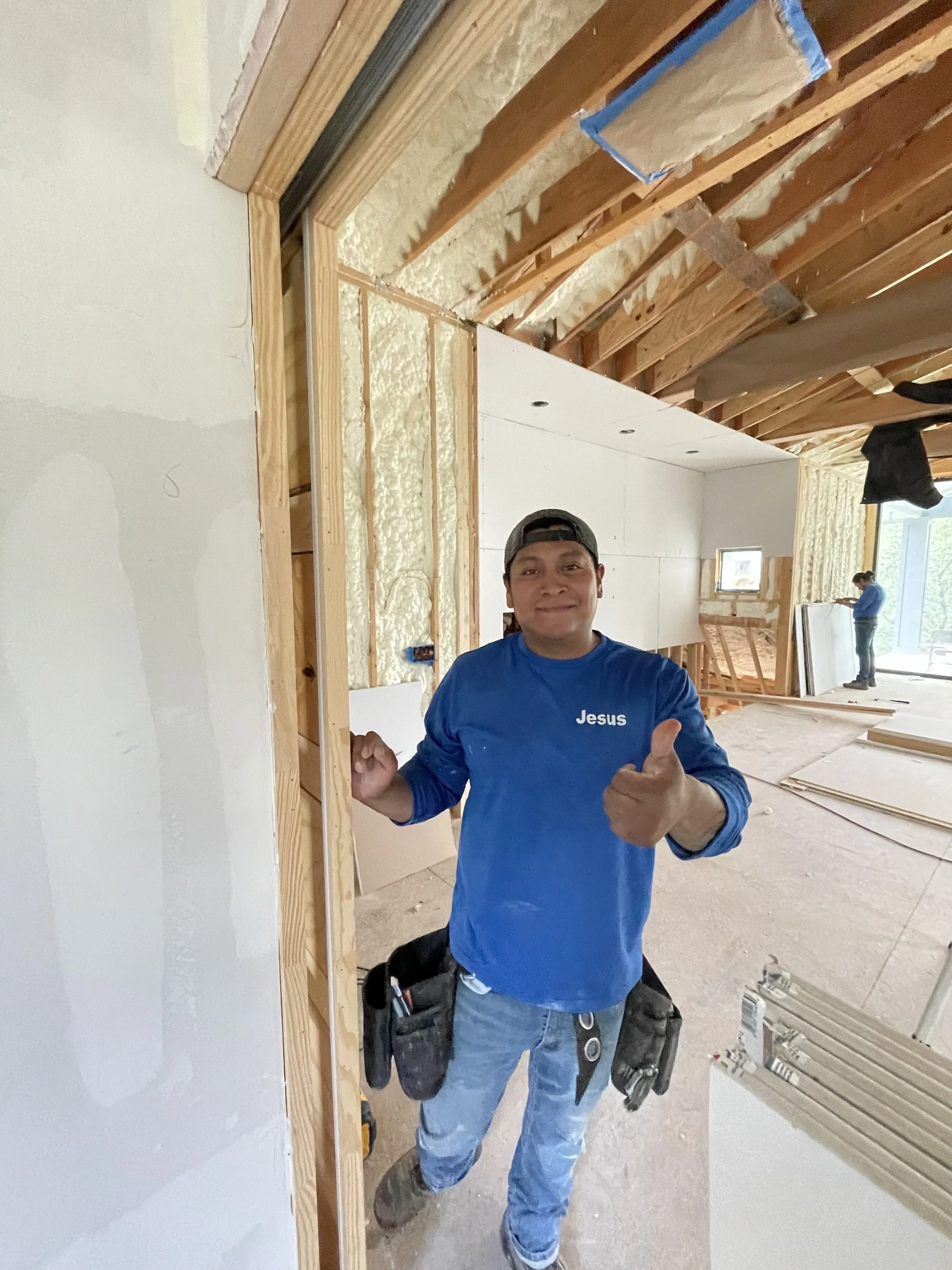 A construction worker in a blue shirt with