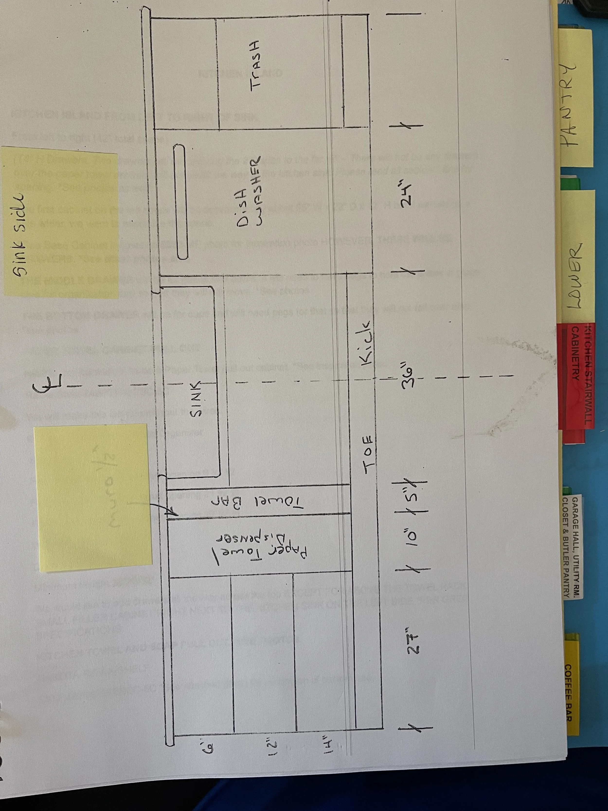 Hand-drawn kitchen layout on paper with labeled areas including sink, dishwasher, full bar, trash, two refrigerators, and a paper towel dispenser. Sticky notes attached to the paper label sink side, pantry, and lower.