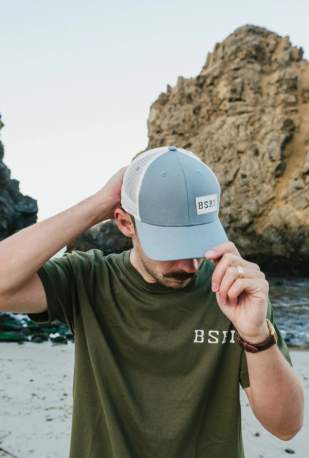BigSurRiverInn-BigSur-GeneralStore-BSRILogo-RusticPatchBallCap-Blue-Front-Male-Angled-PfeifferBeach-HannahOvereemPhoto.jpeg