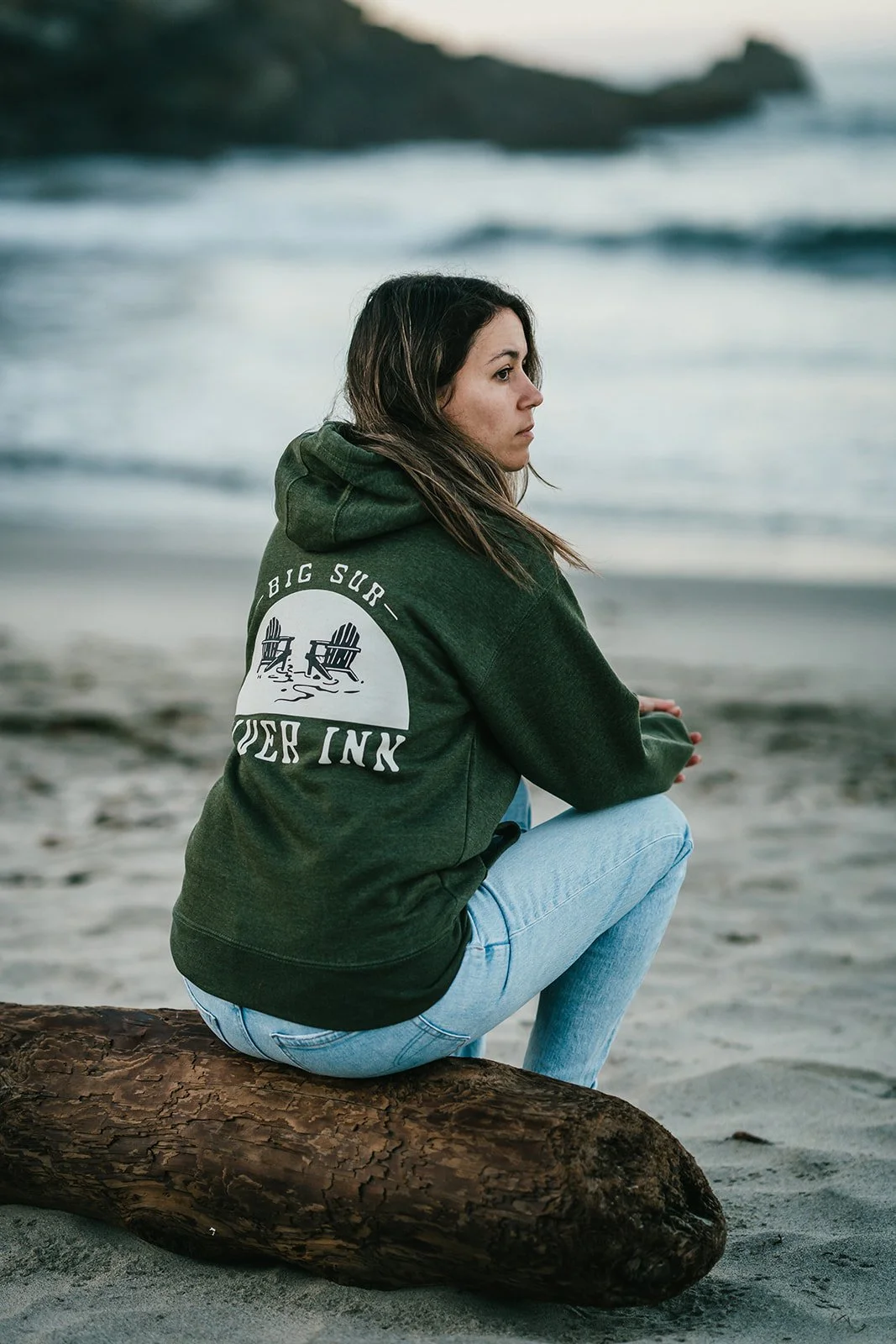 BigSurRiverInn-BigSur-GeneralStore-BSRILogo-Sweatshirt-Green-Back-Female-FullView-Angled-PfeifferBeach-HannahOvereemPhoto.jpeg