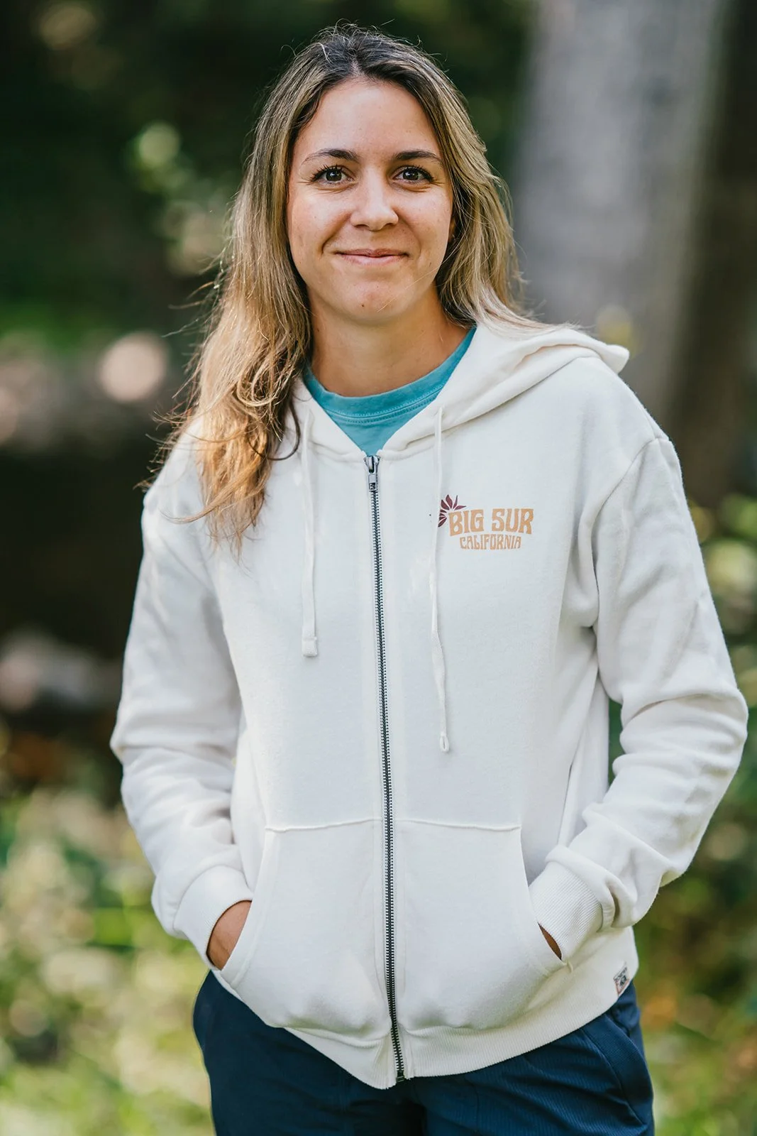BigSurRiverInn-BigSur-GeneralStore-RedwoodFlorals-ZipHoodie-Front-Cream-Female-FullView-BSRILawn-HannahOvereemPhoto.jpeg