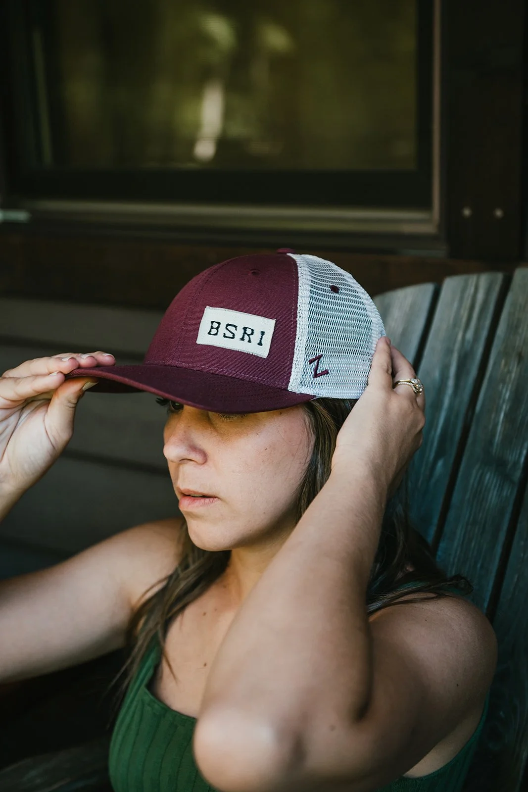 BigSurRiverInn-BigSur-GeneralStore-BSRILogo-RusticPatchBallCap-Maroon-Front-Female-Angled-RiversideSuites-HannahOvereemPhoto.jpeg