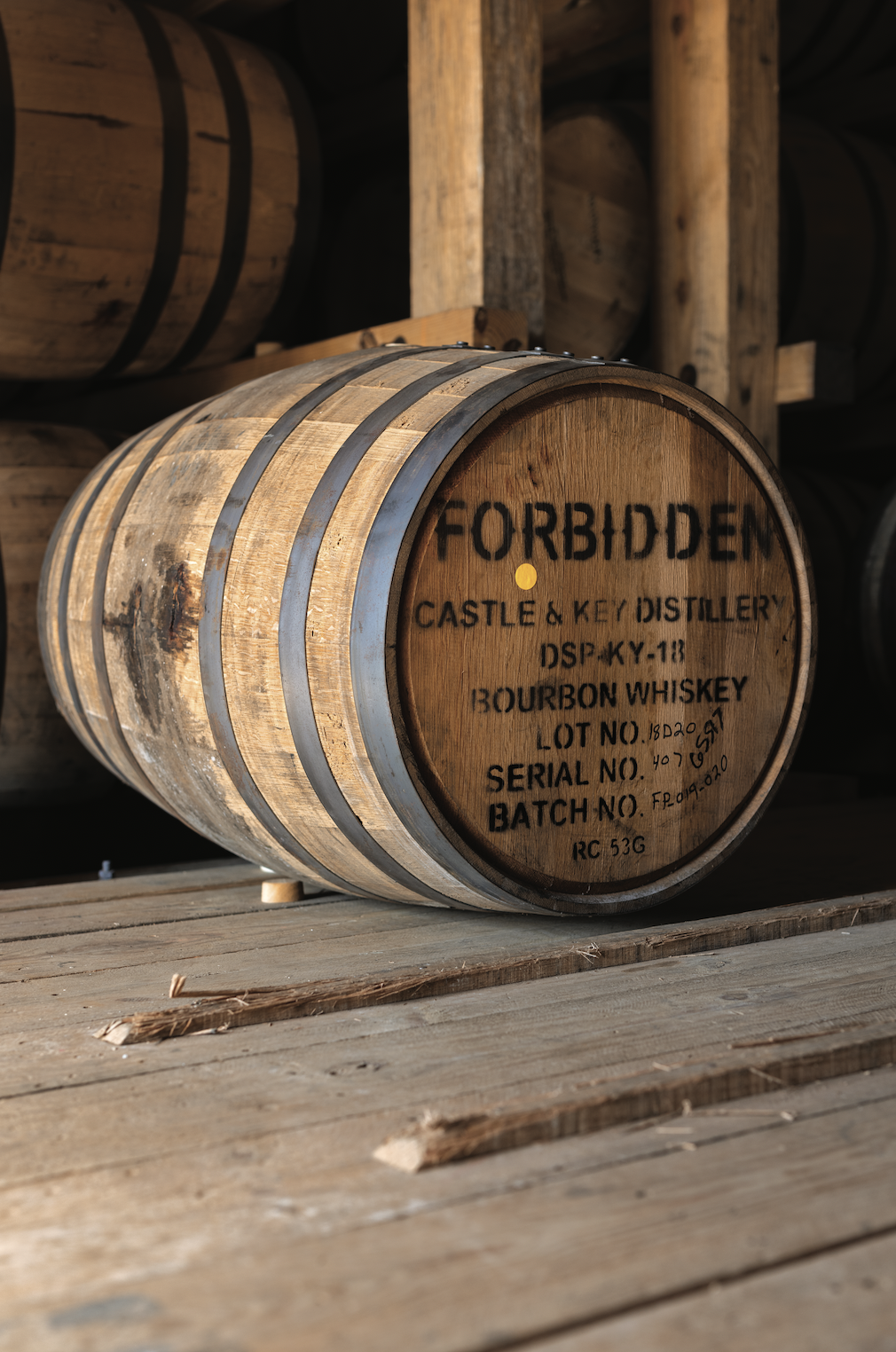  Before she can sample Forbidden Bourbon to test its progress, Eaves taps the barrel with a bung puller that removes the wood stopper, or bung, then extracts the bourbon with a whiskey thief; photography by Paul Mehaffey. 